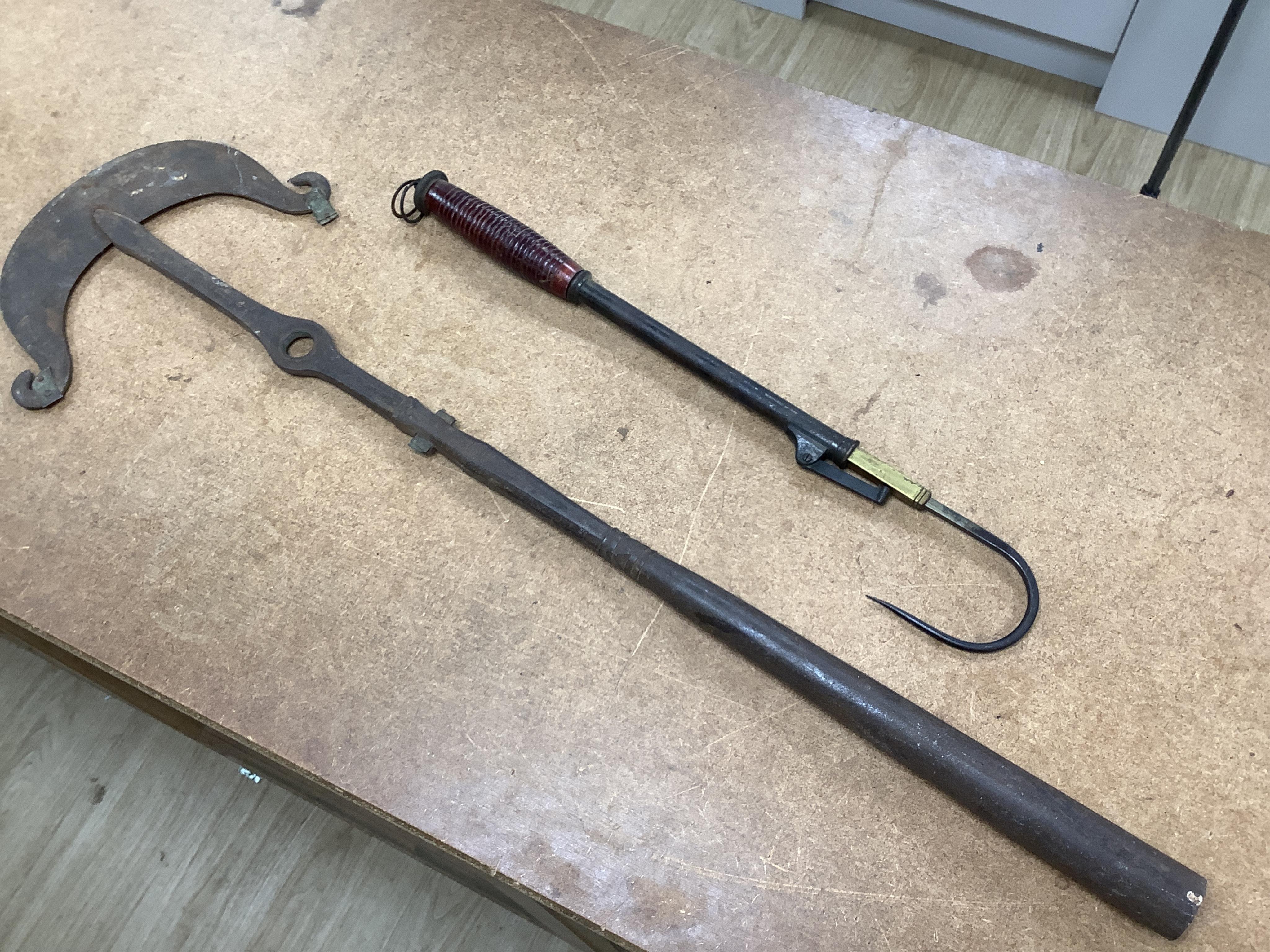 A collection of tribal spears, a fish hook, a cased snooker cue, etc.